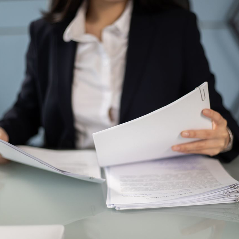 Person reviewing documents at a desk