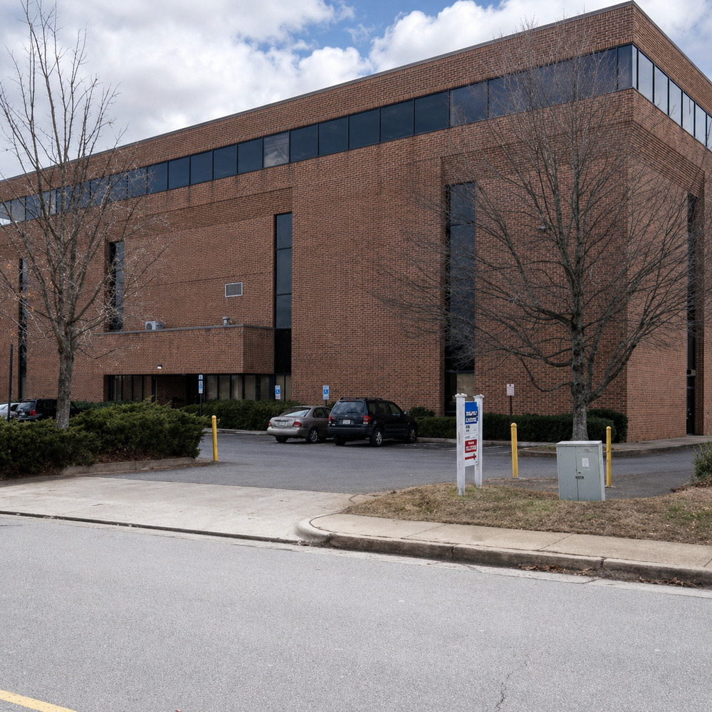 Brick office building beside a parking area